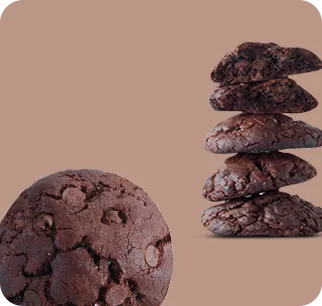 Organic double chocolate cookie dipped in chocolate milk on a brown background.