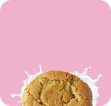 Two sugar cookies sweetened with coconut sugar, made with organic ingredients, and seed oil-free, on a pink background.